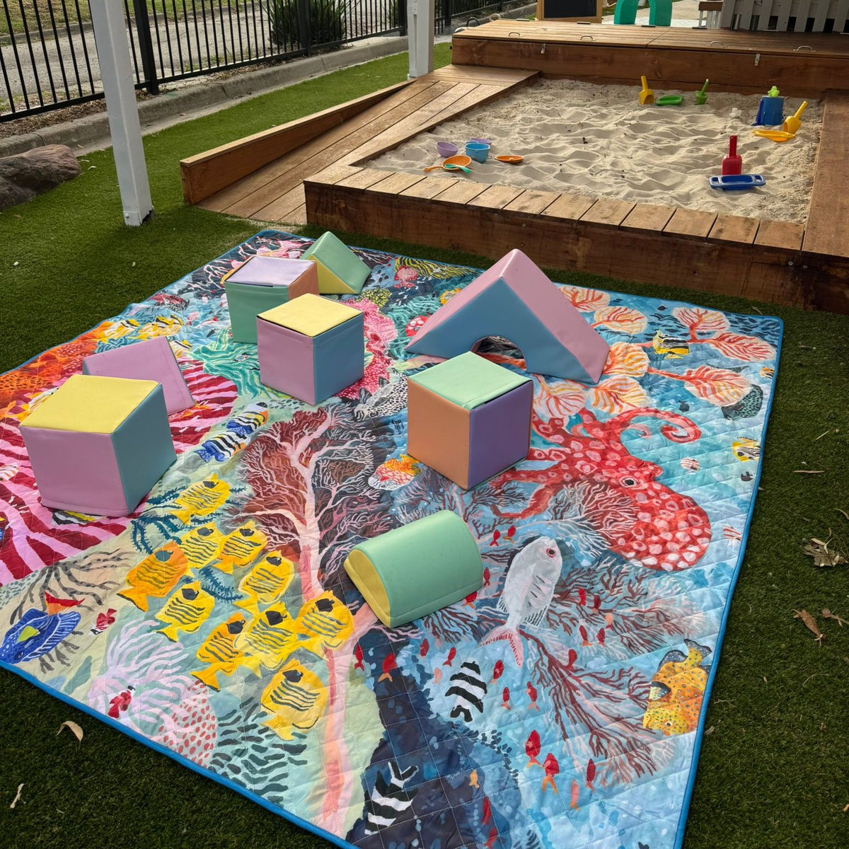 octopus's garden waterproof picnic blanket with soft play blocks in a childcare playground