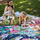 mother with baby and toddler having a picnic on the octopus's garden waterproof picnic blanket